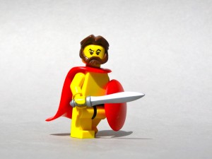 Nine conference mythodologies: A photograph of a yellow Lego warrior wearing a red cape and shield and holding a silver sword. Image attribution: Flickr user dunechaser.