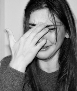 popular on social media: black and white photograph of a sad person with long hair with their hand in front of their face