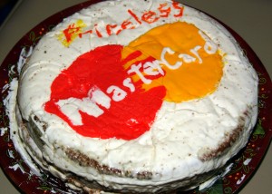 Conversations Relationships Value part 1: a photograph of a large iced cake. The icing on the top shows the Mastercard logo and the word "Priceless".