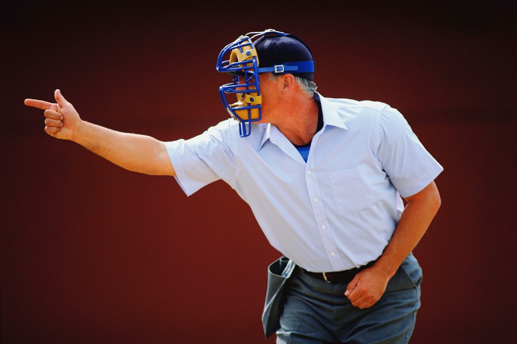 implicit ground rules: photograph of a baseball umpire pointing dramatically