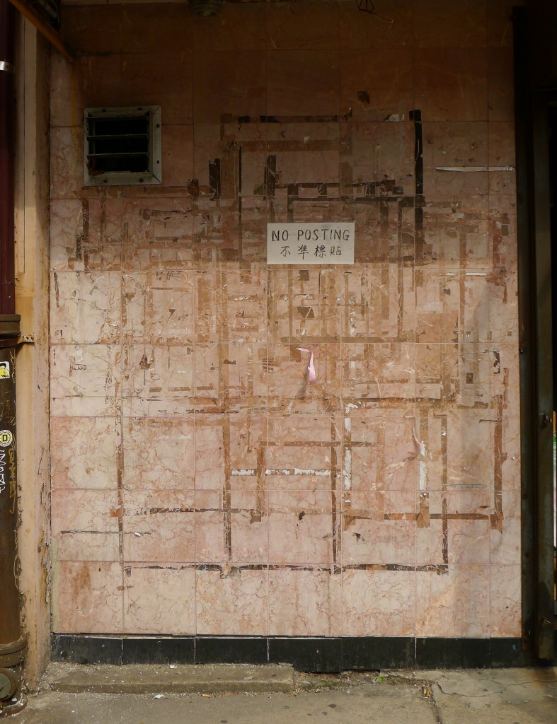 post on walls: photograph of an outside wall with a small barred window. A written sign says "NO POSTING" in English and Chinese. Photo attribution: Flickr user pierrelaphoto