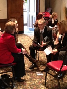 How do you facilitate change: photograph of a small group of people sitting in a circle of chairs