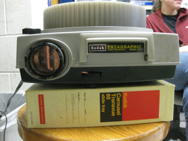 Torn About Technology: photograph of a Kodal Ektagraphic slide projector on top of a Kodak Carousel Transverse 80 slide tray box