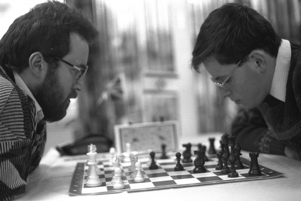 Turning win-lose into win-win. A black and white photograph of two men playing chess.