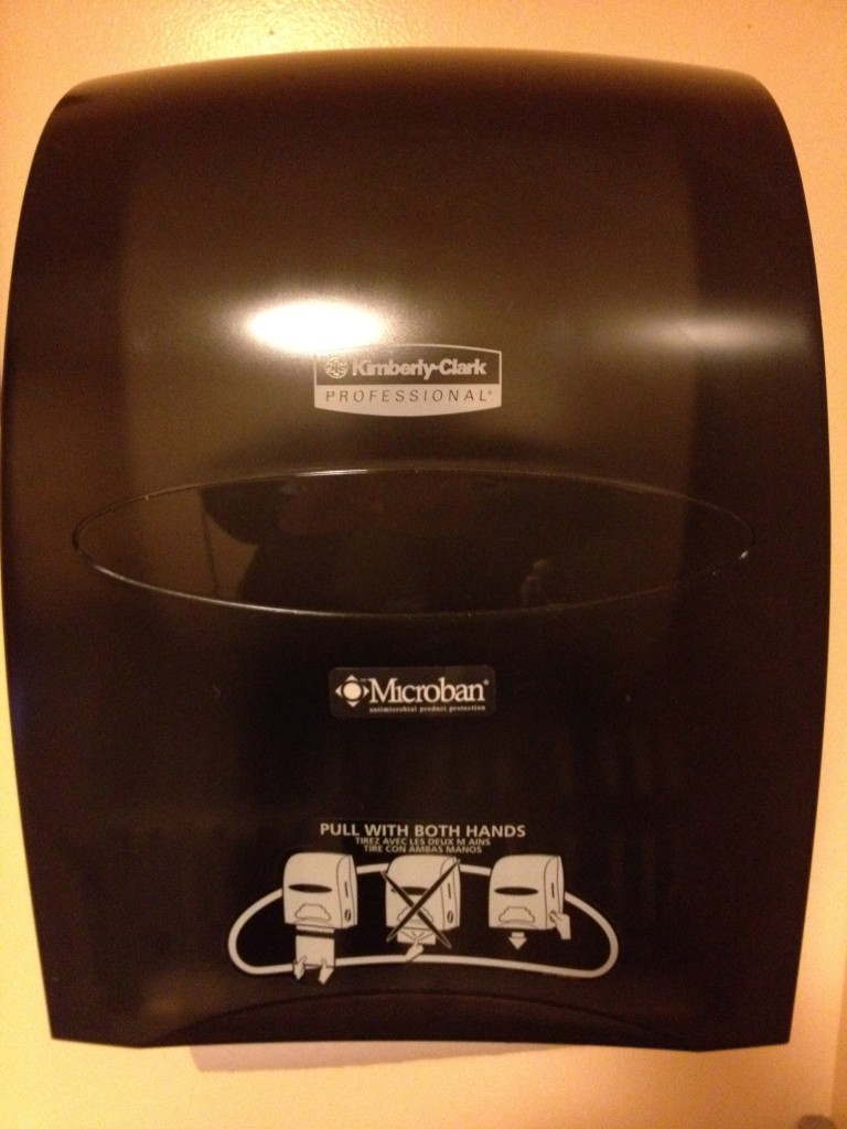 Motivational speaker: photograph of a paper towel dispensing machine that includes the instruction "Pull with both hands"
