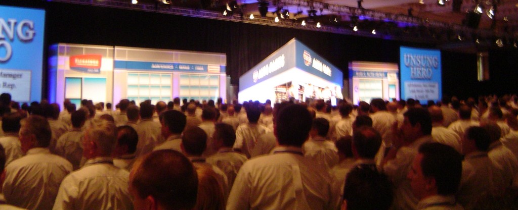 conference size and success: photograph of hundreds of attendees facing a distant and indistinct stage. Photo attribution: Flickr user markizay