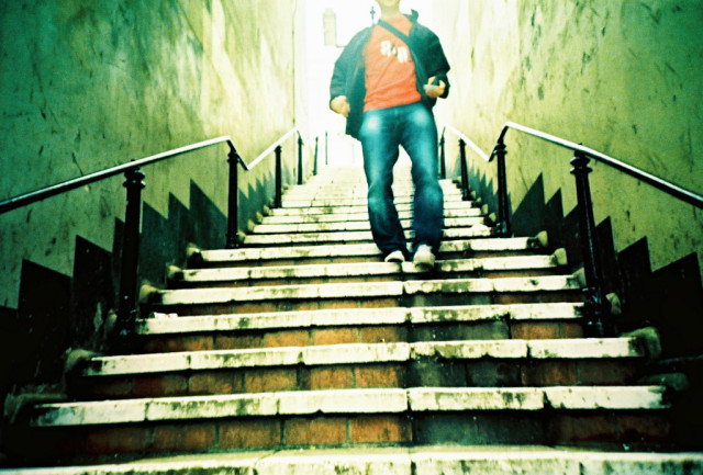 association leadership transitions: a photograph in distorted colors of a person walking toward the camera down a subterranean flight of steps