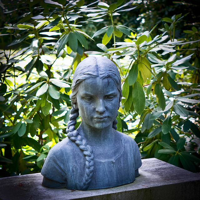 live your life: photograph of a sculpture of the bust of a woman, placed on a bench in a garden. Photo attribution: Flickr user x1klima