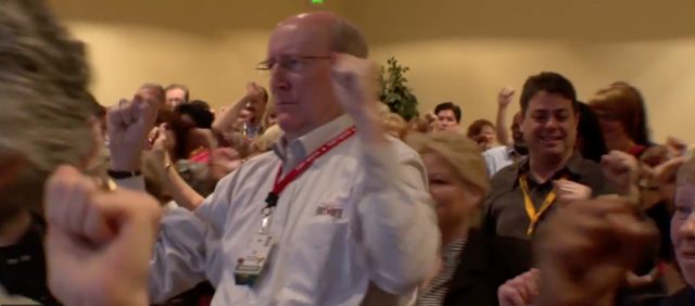 Children and adults shouldn’t sit still in class: photograph of attendees dancing at a conference. Image attribution: Screen capture from X bytes video.