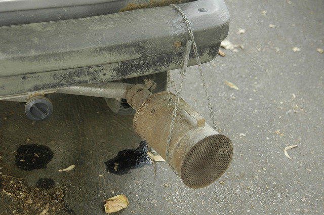 automated marketing: A photograph of a damaged catalytic converter attached with a chain to a car's rear bumper. Image attribution: Flickr 