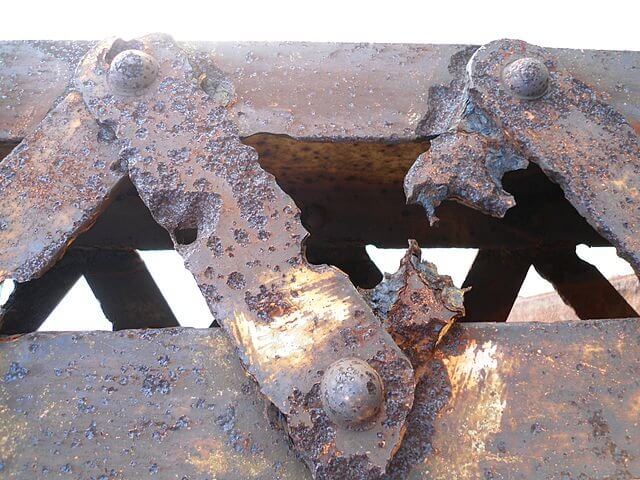 The corrosive effect of commissions on the meetings industry: a photograph of a corroded truss on a metal girder