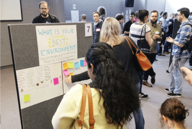 Photograph of participants reviewing posters at The UnExpo Experiment. Photo attribution: Samantha Cooper