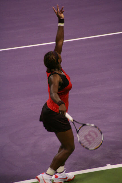 Aim to serve: a photograph of Serena Williams about to serve a tennis ball. Photo attribution: Flickr user tuttotutto