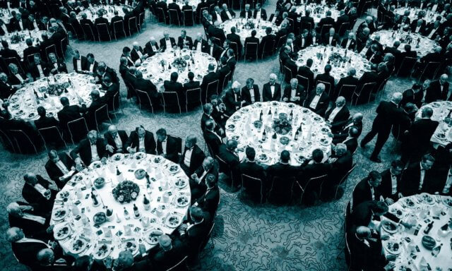 dinner seating - a study: 1839 photograph of a formal dinner. Huge round tables with 16 formally dressed men at each. The tables are crowded together. Image attribution: The Guardian