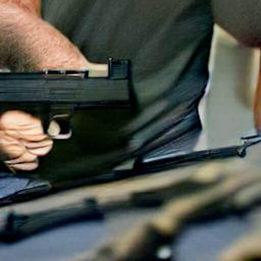 An illustration of guns and power: a man holds a gun, with more guns on a table nearby