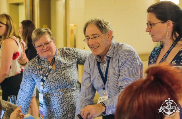 Attracting great consulting clients: photograph of Adrian Segar—in striped shirt—working with participants during a peer conference