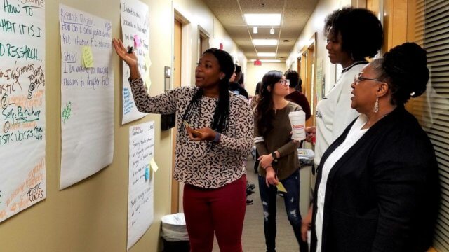 Photograph of women at a gallery walk, illustrating how to improve breakout gallery walks.