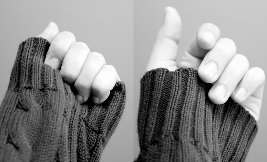 let go: black and white photograph of (on left) fingers holding the cuff of a sweater over the hand (on right) fingers letting go of the cuff of the sweater from the hand "Let Go" by JFXie is licensed under CC BY 2.0.