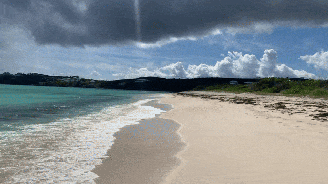 Video of a walk along Anguila's Shoal Bay East beach, panning to waves breaking over the island's coral reef.